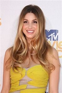 Whitney Port wears black tights with Converse