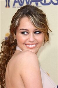 Miley Cyrus dons fishnet tights for MTV performance