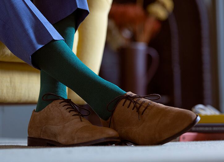 Man in dark green socks and brown suede shoes