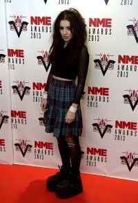Charli XCX works laddered tights