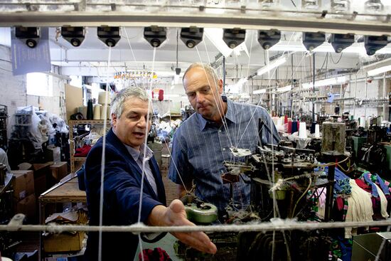 Factory owner, Neil Swift, showing Sir Steve a piece of machinery that helps the production of his new socks.