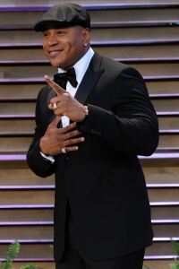 LL Cool J parties wearing a hat