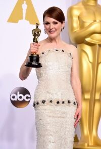 Moore shows less during Oscar triumph