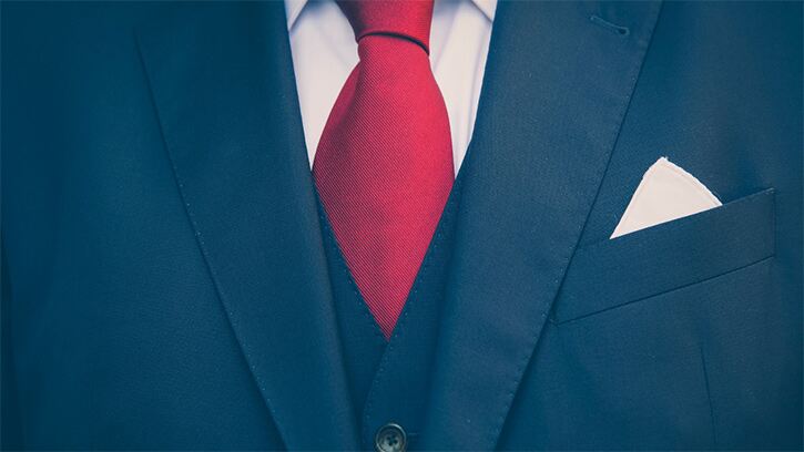 Navy suit with white shirt and red tie
